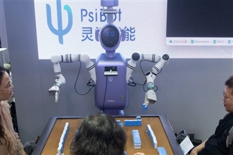 Psi-Robot showcases its humanoid robot R1 playing mahjong. Credit: AFP